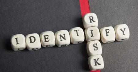 Risk indentify crossword blocks on table. Top view.